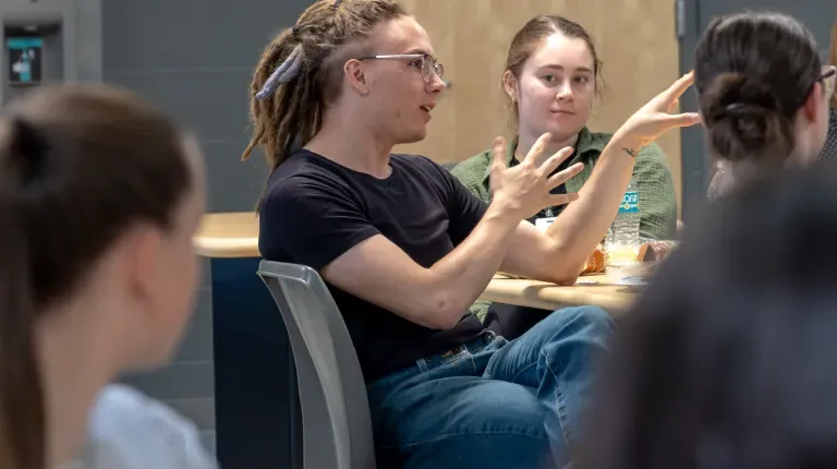 Student asks a question during a panel discussion.